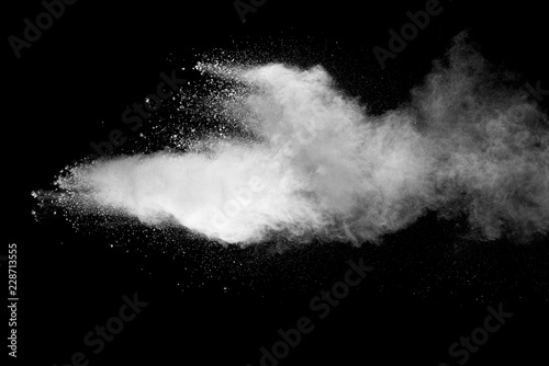 Explosion of white dust on black background.