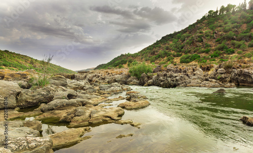 Rio Guadiana going down between the rocks and mountains photo