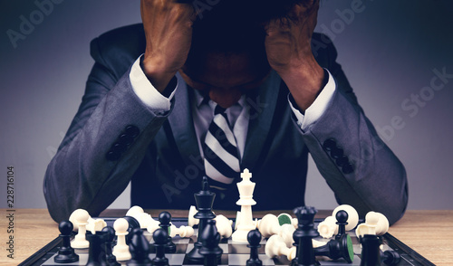 Photography businessman playing chess board