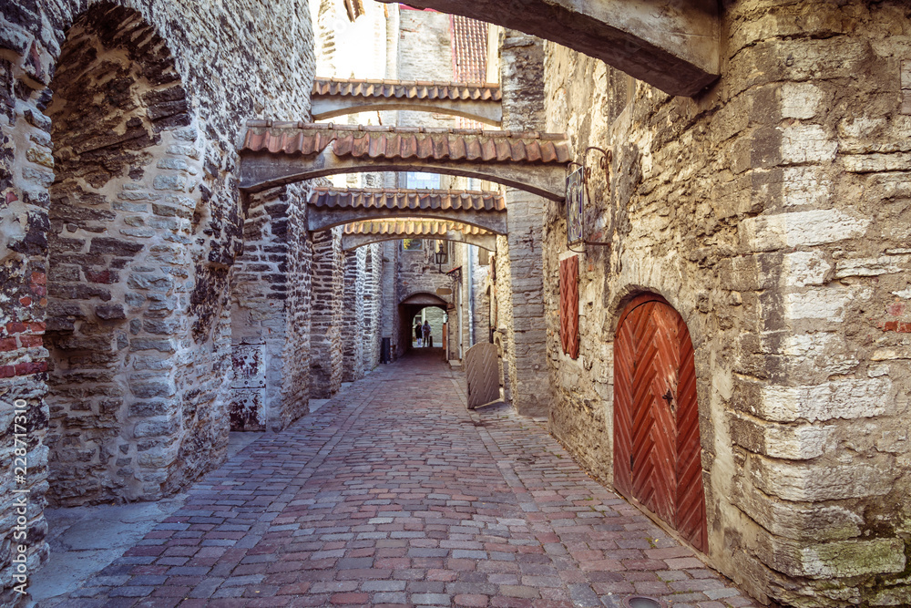 Fototapeta The St Catherine's Passage is historical cobbled street in the old town of Tallinn, Estonia
