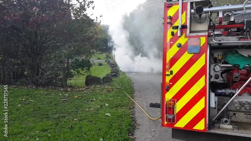fire brigade dealing with burned out car uk