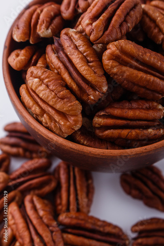 delicious pecan nuts on a white acrylic background