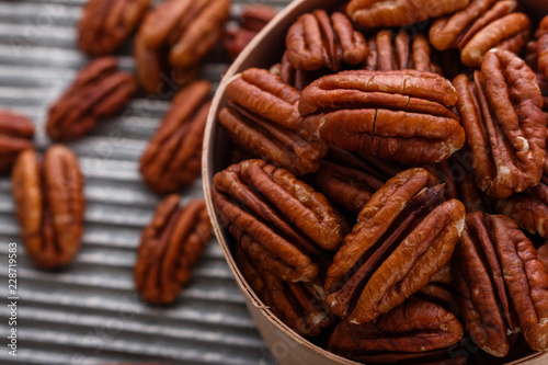 delicious pecan nuts on a rustic wooden background