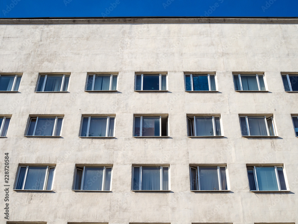 Fototapeta premium front view of white urban building in sunny day