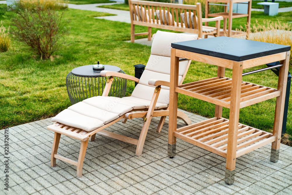 Outdoor patio with wooden armchairs and table
