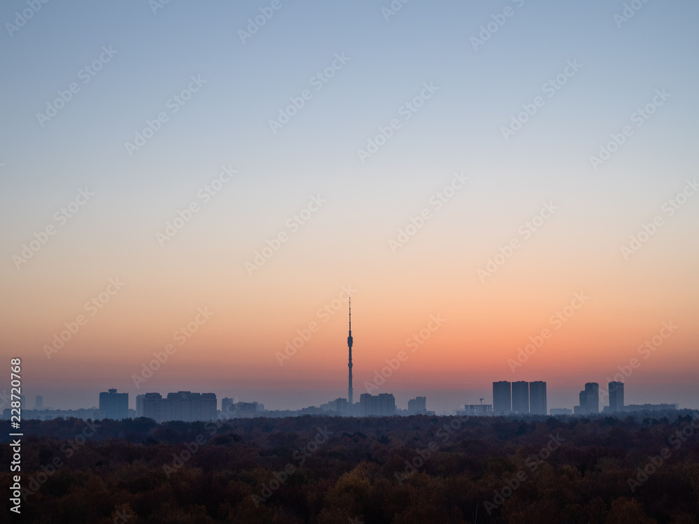 blue dawn sky over city and urban park