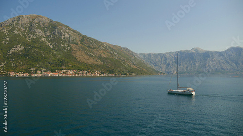 Picturesque view of the waters of the Bay of Kotor and the high mountains rising in the background.