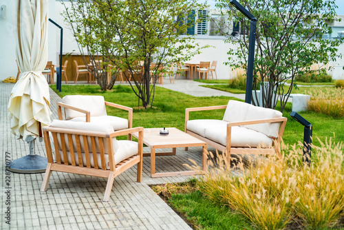 Outdoor patio with wooden armchairs and table