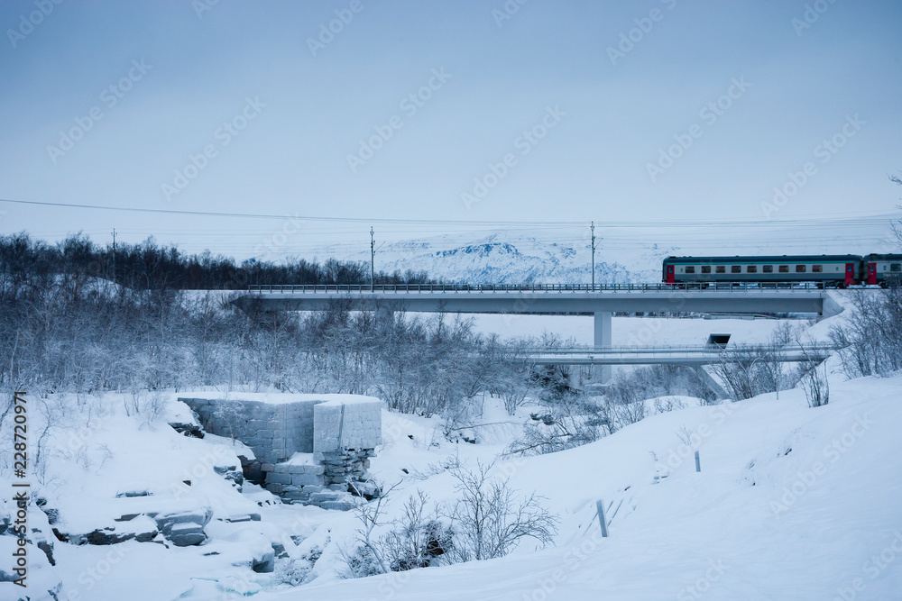ABISKO, SWEDEN Train crossing bridge in Abisko National Park. ABISKO, SWEDEN Train crossing bridge in Abisko National Park.