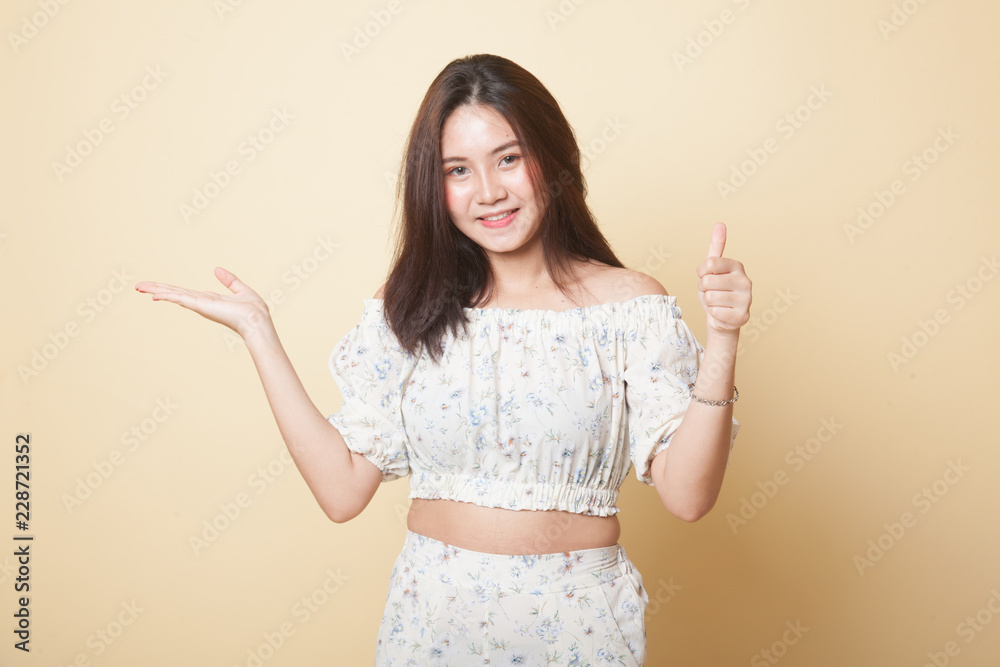 Beautiful young Asian woman show palm hand and thumbs up. Beautiful young Asian woman show palm hand and thumbs up.