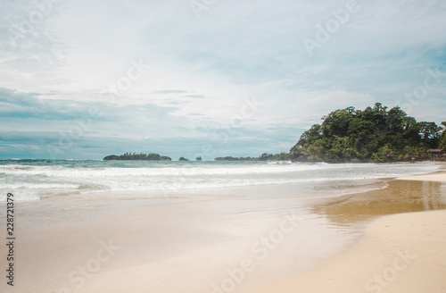 Fototapeta Naklejka Na Ścianę i Meble -  Windy day on the wide white sand of Red Frog Beach, a Caribbean island off the coast of Panama
