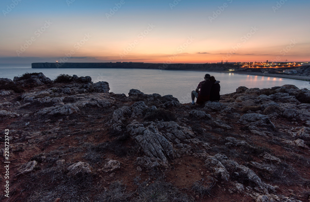 a couple in love over the cliff at sunset romantic concept