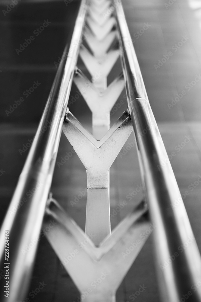 a metal handrail at stairs in the urban - close up - monochrome a metal handrail at stairs in the urban - close up - monochrome