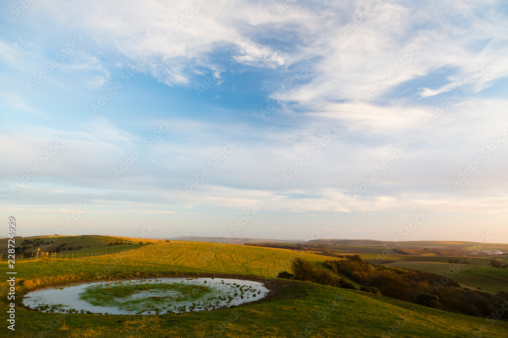 Fototapeta premium Ditchling Beacon, Sussex, UK. Small circular pond at Ditchling Beacon.