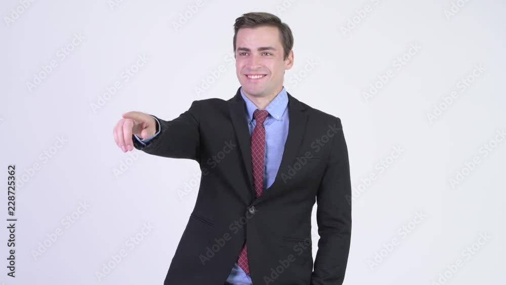 Young happy handsome businessman pointing finger Young happy handsome businessman pointing finger