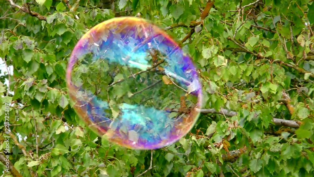 Iridescent colors of the soap bubble in the air.  Show Object in the air close. 