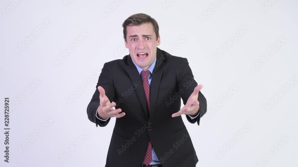 Young angry businessman talking to camera Young angry businessman talking to camera