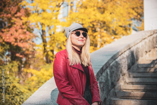 A woman of plus size, American or European appearance walks at park enjoying life. Nice beautiful lady with excess weight, rest at city park 