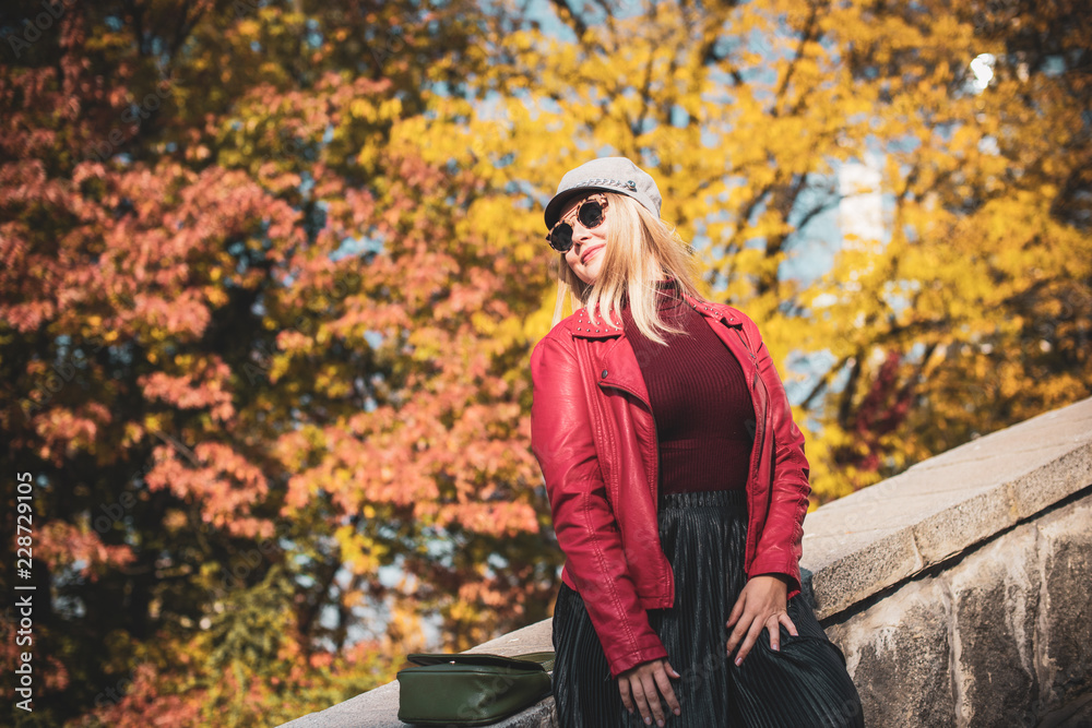 A woman of plus size, American or European appearance walks at park enjoying life. Nice beautiful lady with excess weight, rest at city park 