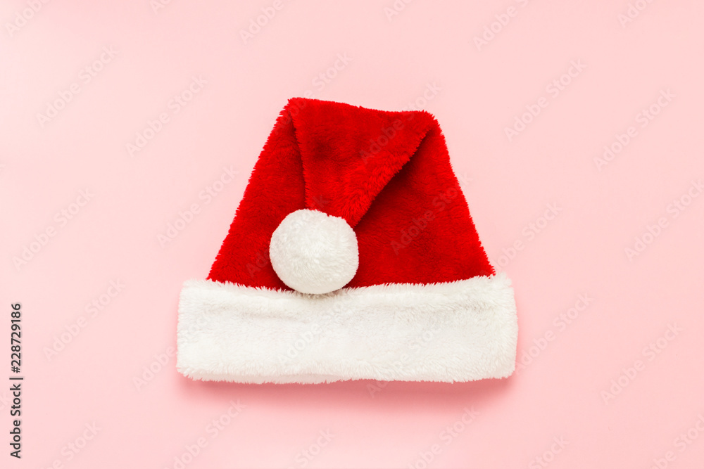 Santa Claus hat on a gently pink background. Concept New Year an Santa Claus hat on a gently pink background. Concept New Year an