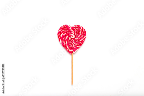 Heart Lollipop on a gently white isolated background. Concept of