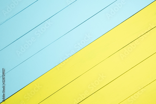 Top view yellow and light green wooden background.