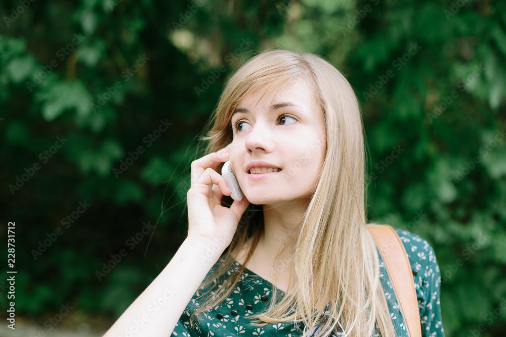 Beautiful young woman talking over mobile phone outdoor Beautiful young woman talking over mobile phone outdoor