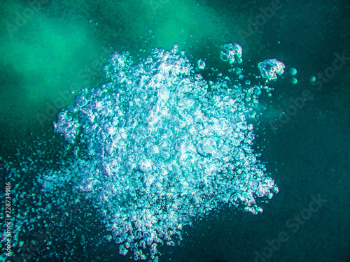 Air boobles in blue sea water. photo