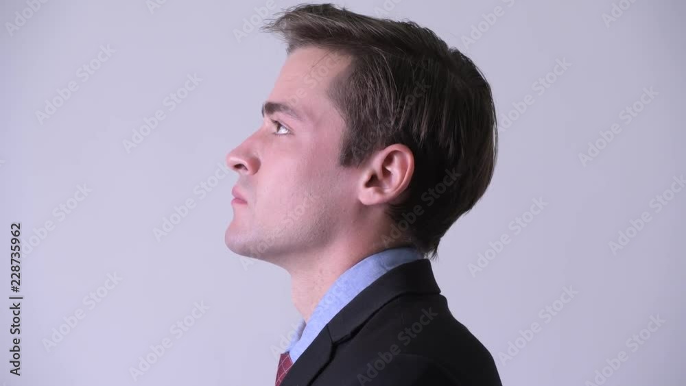 Head shot profile view of young handsome businessman looking up Head shot profile view of young handsome businessman looking up