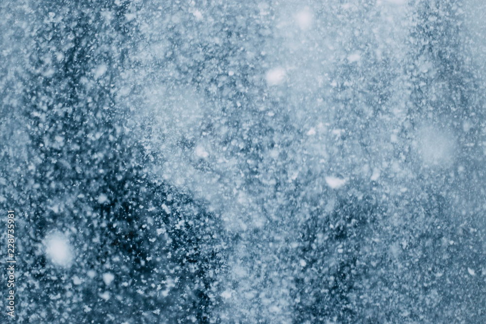 background texture of blizzards, snow flakes in winter. avalanche in the mountains.