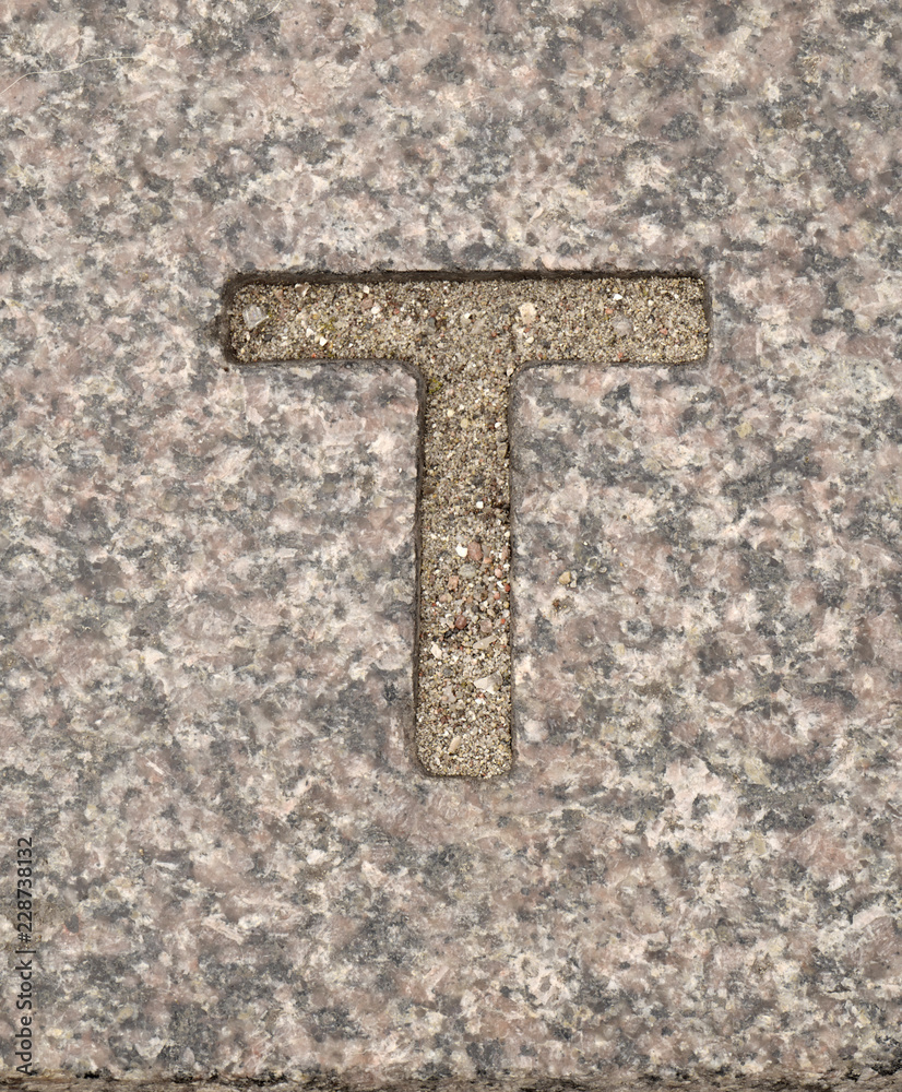 Letter T. On stone background