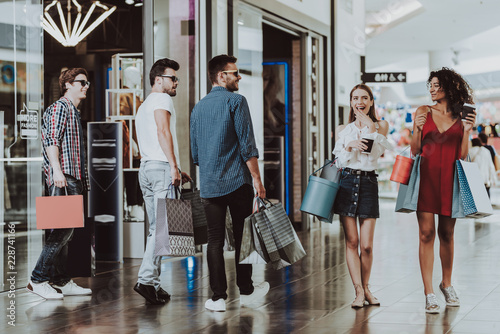 Canvas Print Company of Friends Shopping in Mall with Packages.