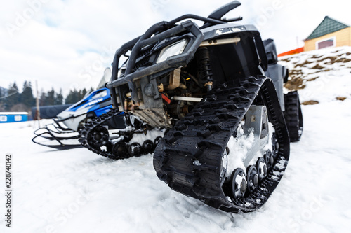 Two snowmobiles in the mountains at ski resort