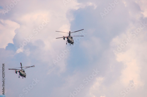 Helicopters with two propellers in a cloudy sky