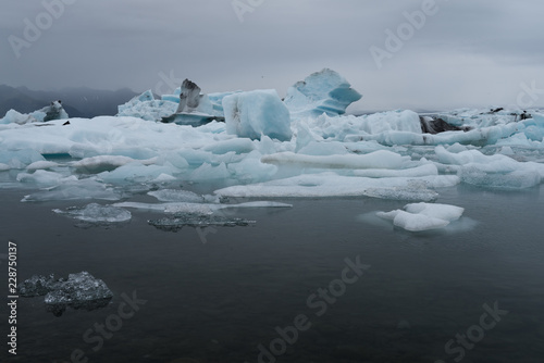 Stunning atmosphere of huge iceberg reflecting in the cool glacial water near the glacier. Glacial Lake jokulsarlon iceland, the Atlantic Ocean.