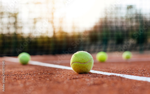 Tennis balls on tennis court. © kojala