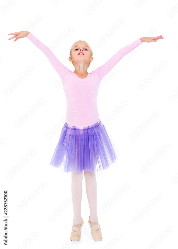 Little girl ballerina performs dance.