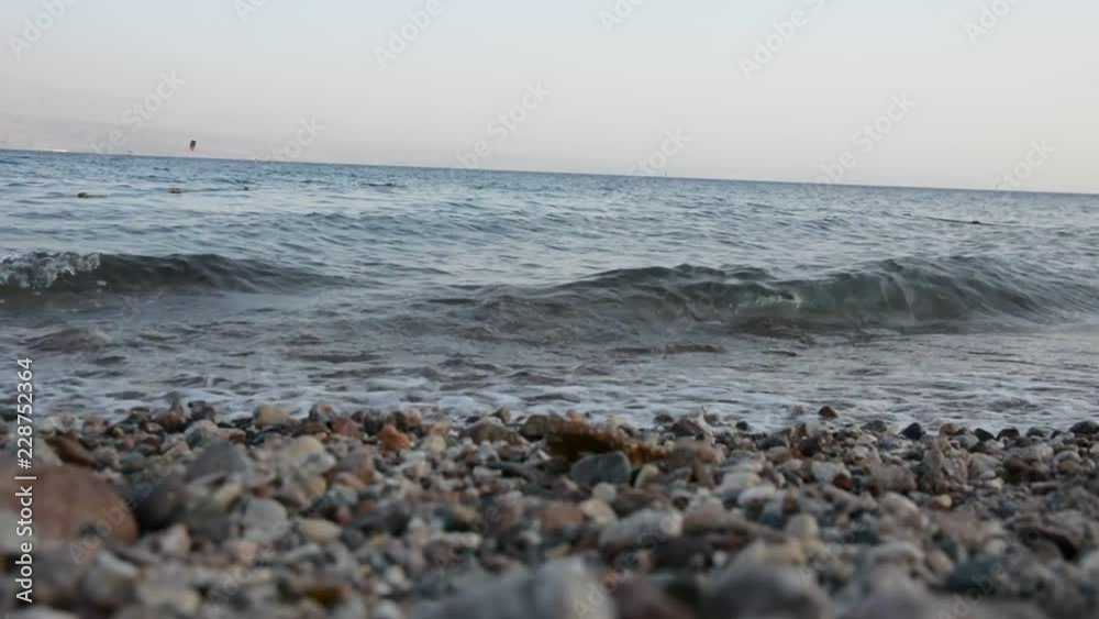 Clear Sea Waves over pebbles Beach. Holiday Background close up, selective focus. Clear Sea Waves over pebbles Beach. Holiday Background close up, selective focus.