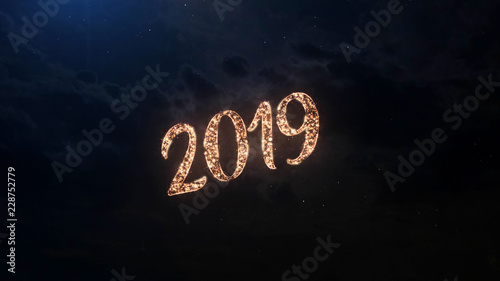 2019 Happy New Year greeting text with particles and sparks on black night sky with colored fireworks on background, beautiful typography magic design.