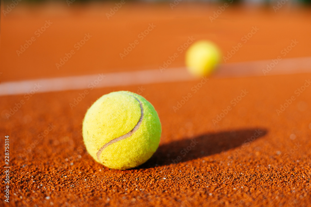 Tennis balls on tennis court.