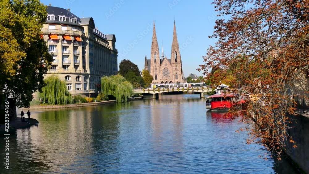 View of St Paul's Church of Strasbourg. In the foreground, there is the Ill river. Filmed in October 2018, during the fall. View of St Paul's Church of Strasbourg. In the foreground, there is the Ill river. Filmed in October 2018, during the fall.