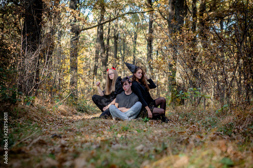 Teenagers in Halloween costumes in the woods