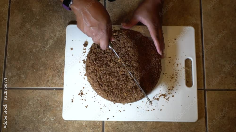 Woman slicing into chocolate cake, Slow Motion Overhead Close Up