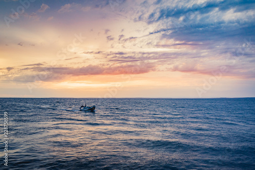 Fishing boat in the blue sea at dusk with blue sky in the city of S  o Jos   do Ribamar  Maranh  o state  Brazil