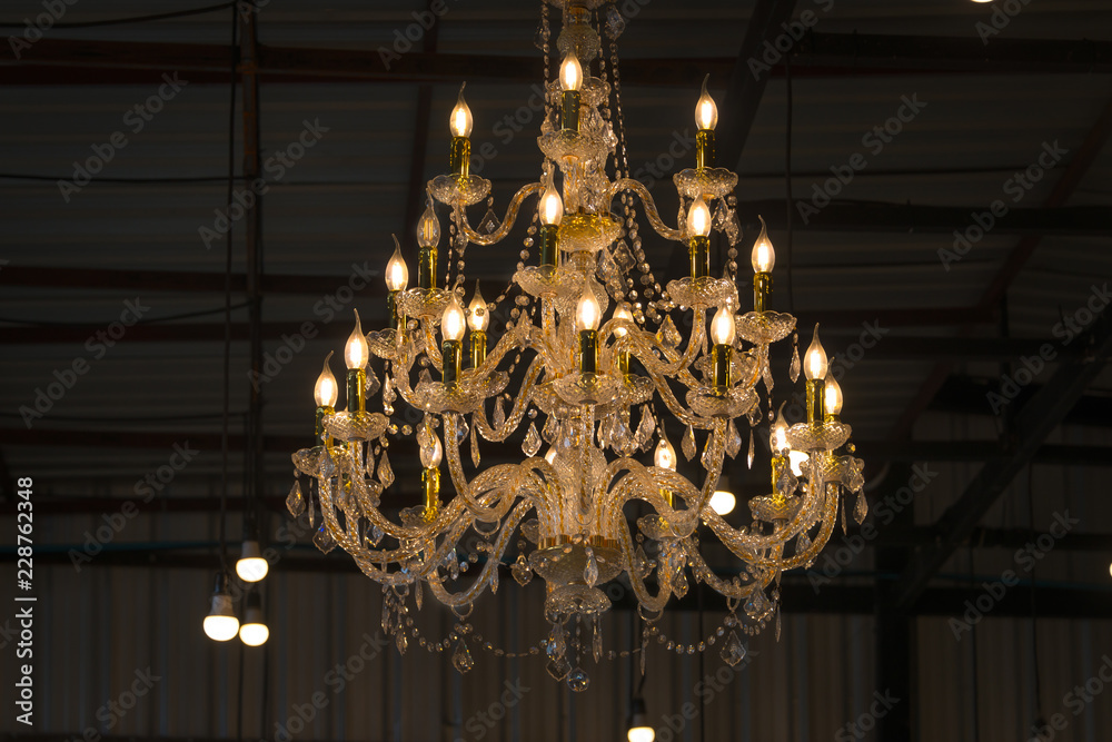 Luxury chandelier in the light bulbs hanging from the ceiling retro style on dark background