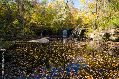 Waterfall in Banning State Park long exposure during daytime in the fall with beautiful fall foliage colors to the trees photo