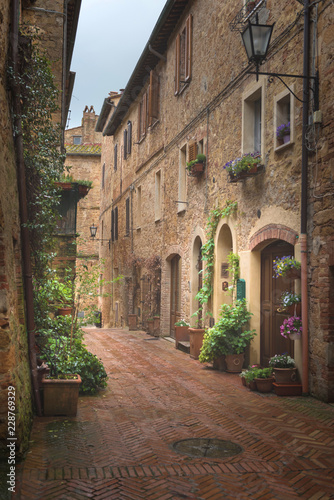Flowery streets on a rainy spring day in a small magical village Pienza  Tuscany