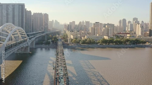 fly over- iconic songhua river railway bridges, single track historic steel bridge converted to walkway (zhongdong) museum next to modern arched railway bridge, photo