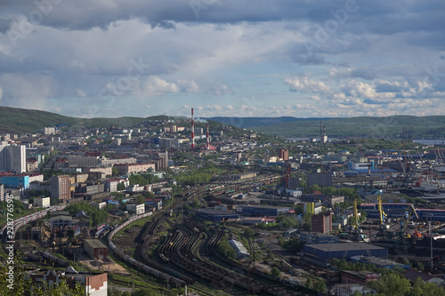 The urban landscape of the Murmansk Soviet architecture and the bright foliage of summer.