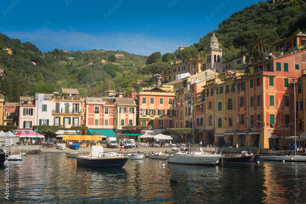 The beautiful Portofino panorama with colorfull houses, luxury boats and yacht in little bay harbor. Liguria, Italy